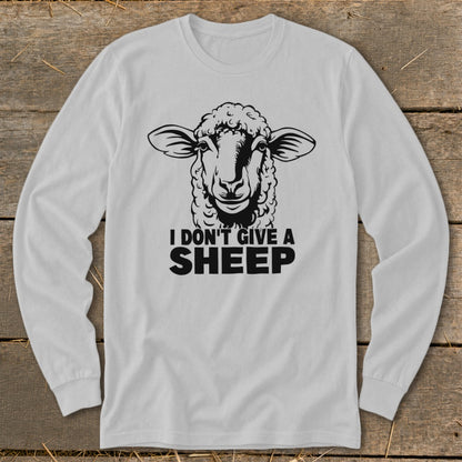 White long-sleeve shirt with a black graphic of a sheep and text that reads "I DON'T GIVE A SHEEP".