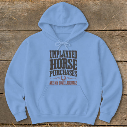 Light blue hoodie with "Unplanned Horse Purchases Are My Love Language" text and horseshoe graphic.