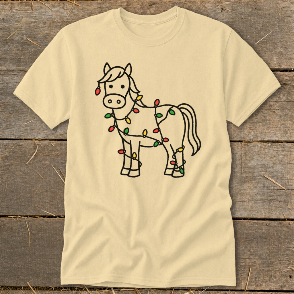 Light beige t-shirt with a black outline drawing of a horse wrapped in Christmas lights.