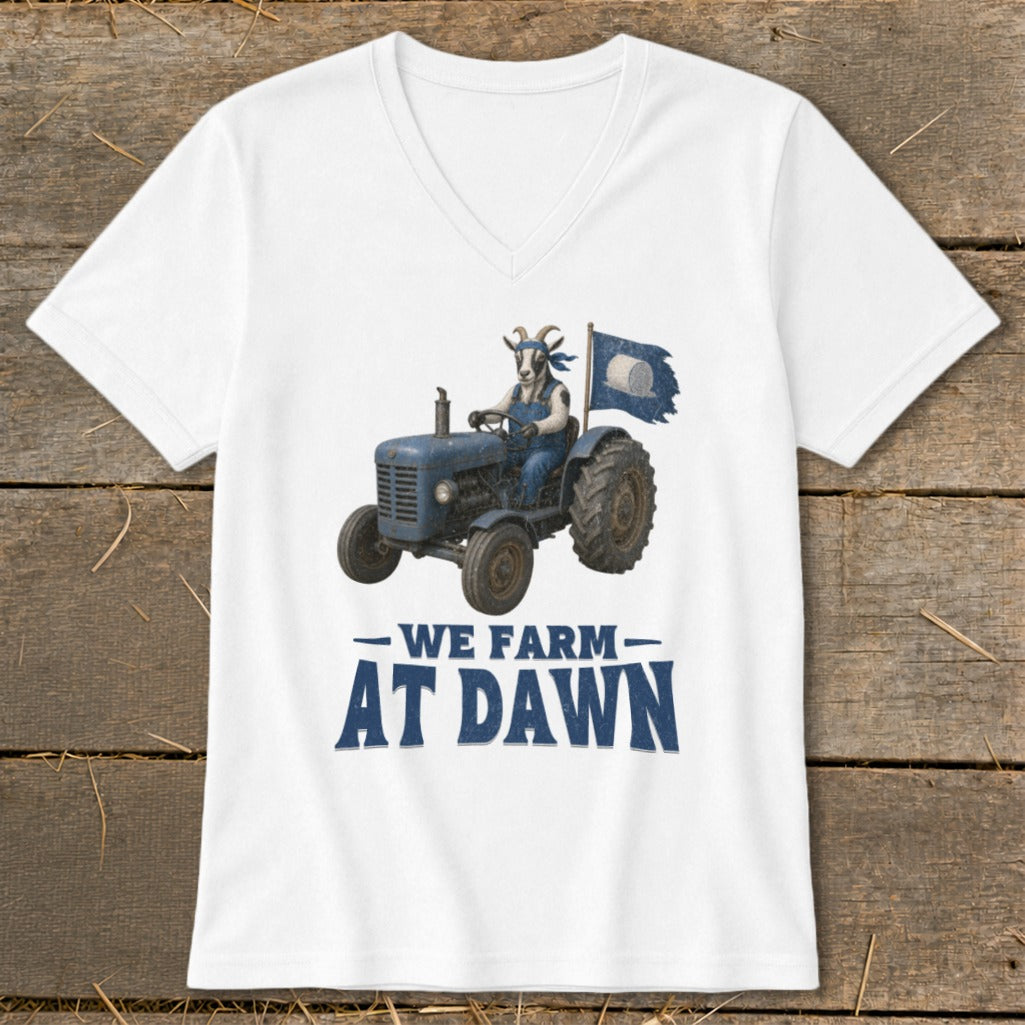 Goat in overalls drives tractor with flag, text "We Farm At Dawn".