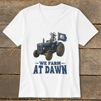 Goat in overalls drives tractor with flag, text "We Farm At Dawn".