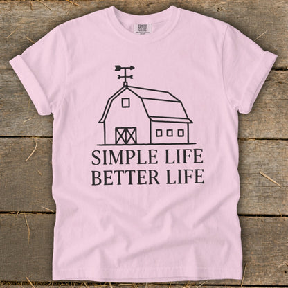 Pink t-shirt with barn graphic and text "SIMPLE LIFE BETTER LIFE".