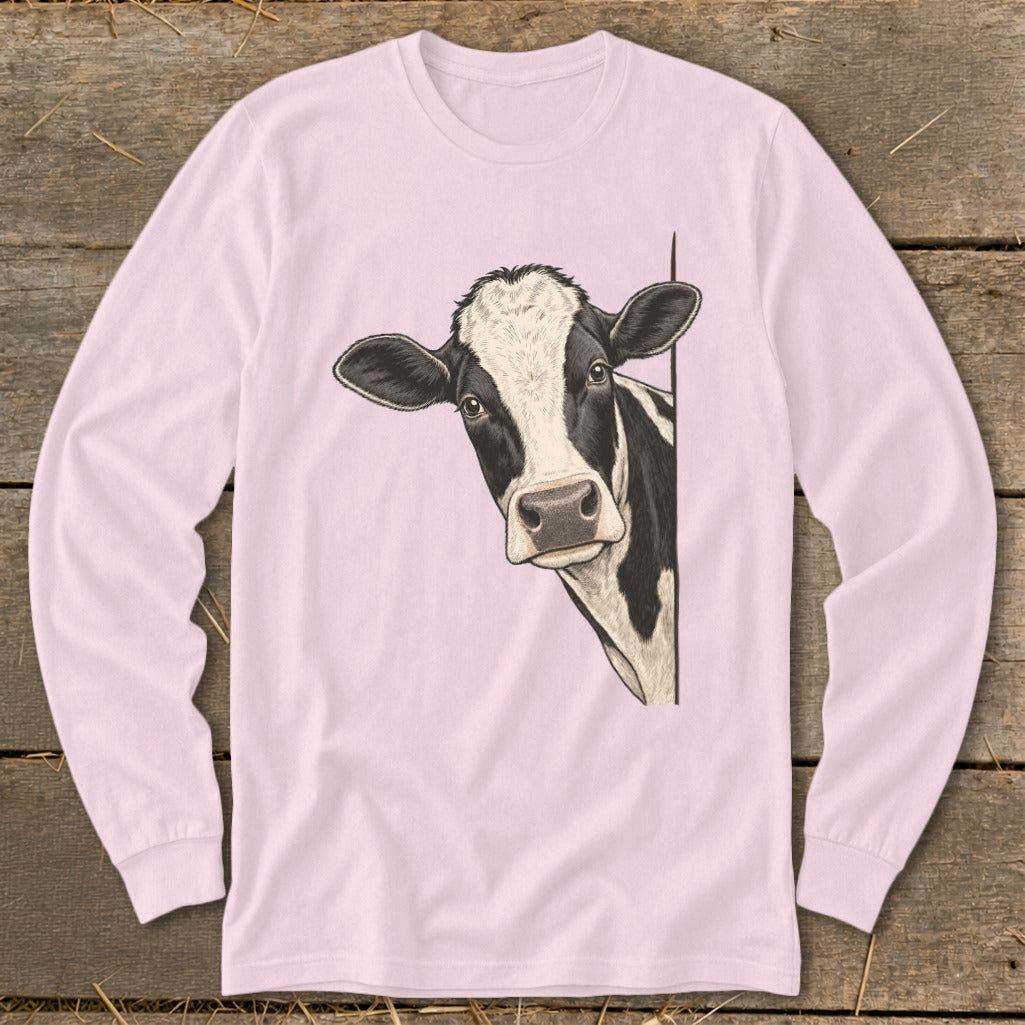 Black and white cow peeking from behind a light pink long-sleeve shirt.