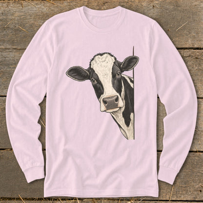 Black and white cow peeking from behind a light pink long-sleeve shirt.