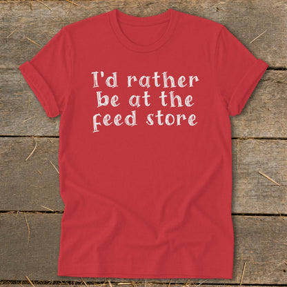 Red t-shirt with white text that reads "I'd rather be at the Feed store."
