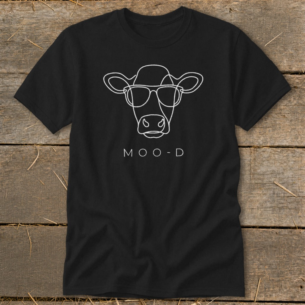Black t-shirt with a white outline of a cow wearing sunglasses and the text "MOO-D".
