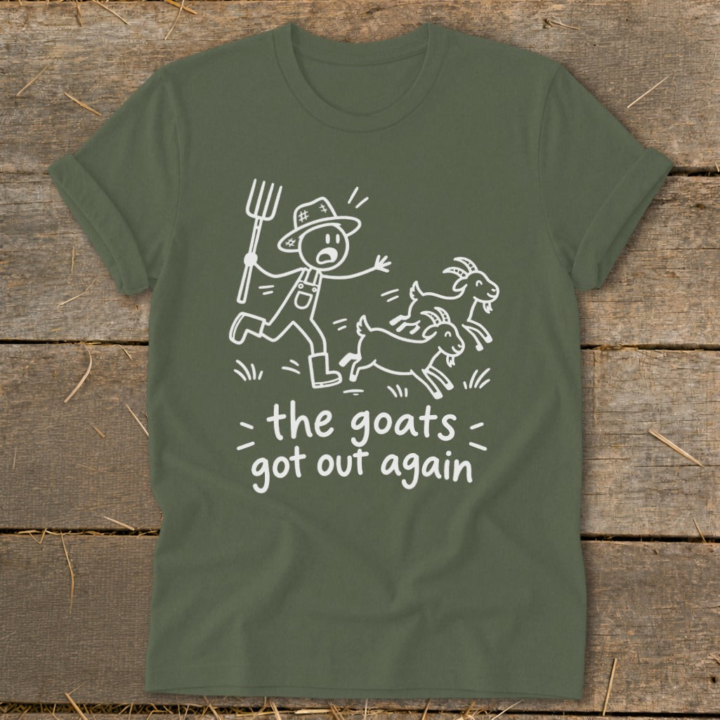 Green t-shirt with white cartoon of farmer chasing goats with text "the goats got out again".