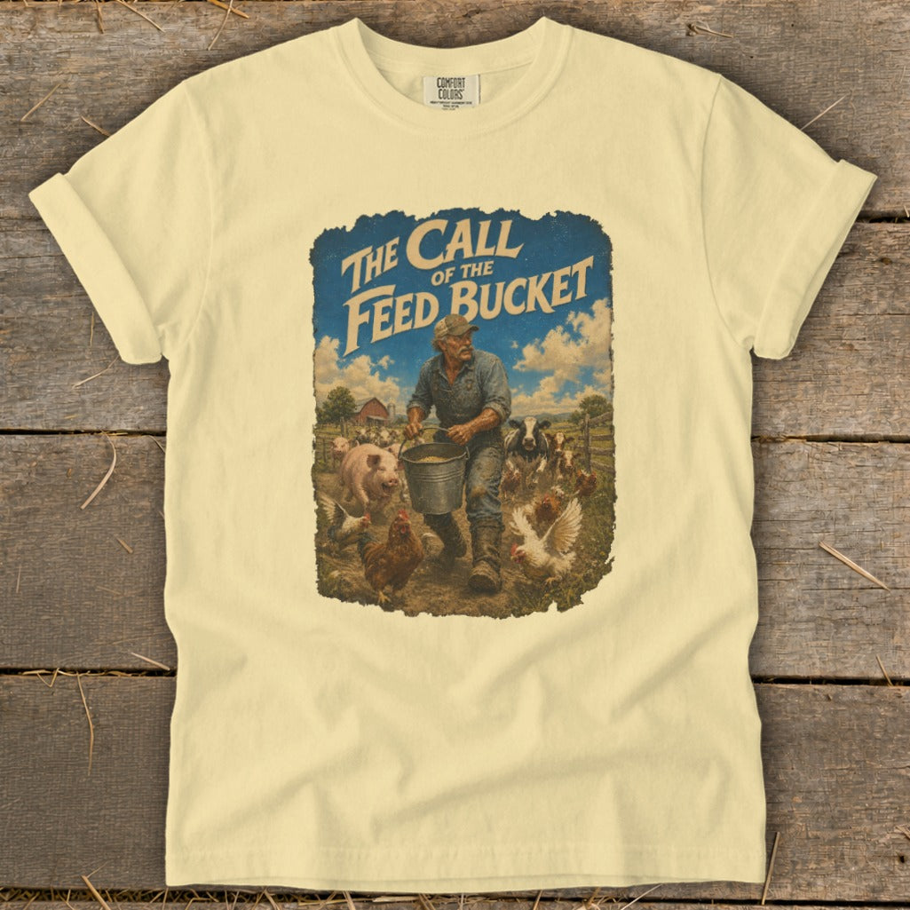 T-shirt graphic: Farmer feeding animals, "The Call of the Feed Bucket" text.
