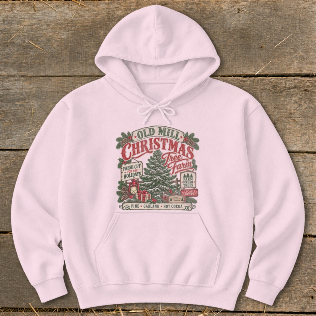 Pink hoodie featuring "Old Mill Christmas Tree Farm" graphic with pine trees and gifts.