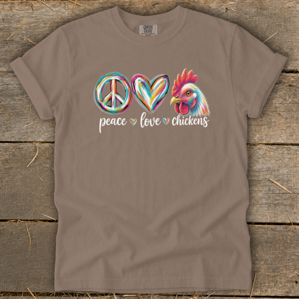T-shirt with colorful peace, love, and chicken graphics and text.