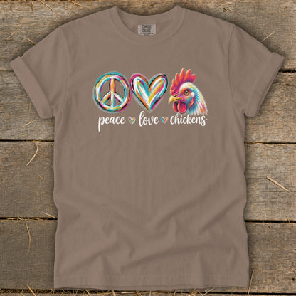 T-shirt with colorful peace, love, and chicken graphics and text.