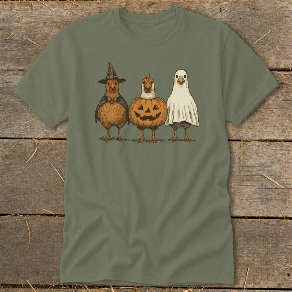 Three chickens dressed in Halloween costumes: witch, pumpkin, and ghost.