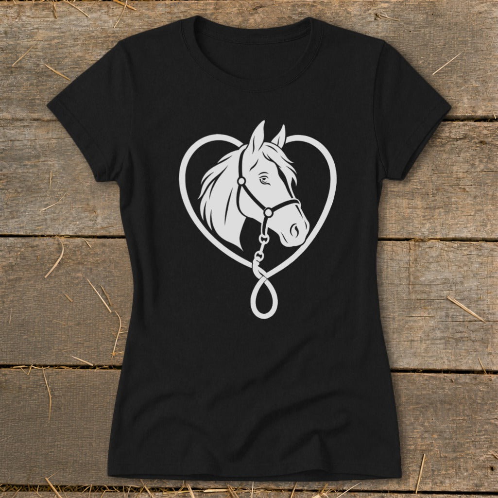 Black t-shirt featuring a white graphic of a horse head inside a heart on a wooden surface.