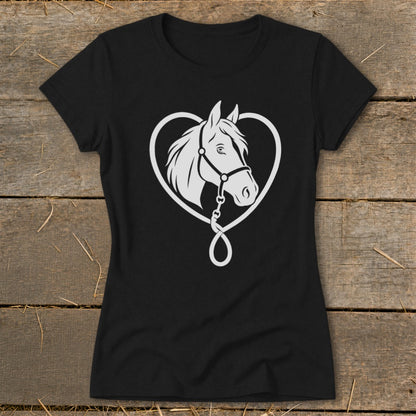 Black t-shirt featuring a white graphic of a horse head inside a heart on a wooden surface.