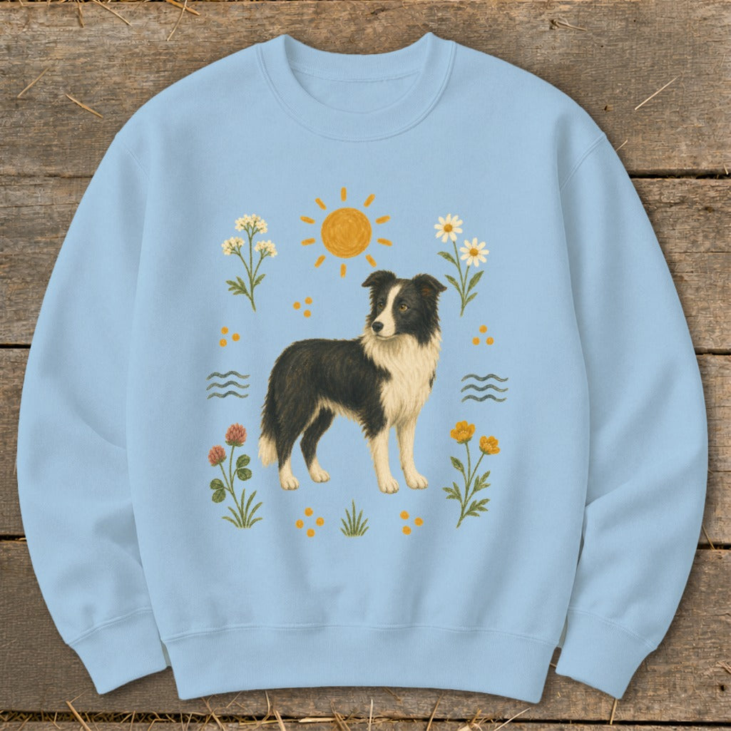 Light blue sweatshirt with a Border Collie dog, sun, and floral print.