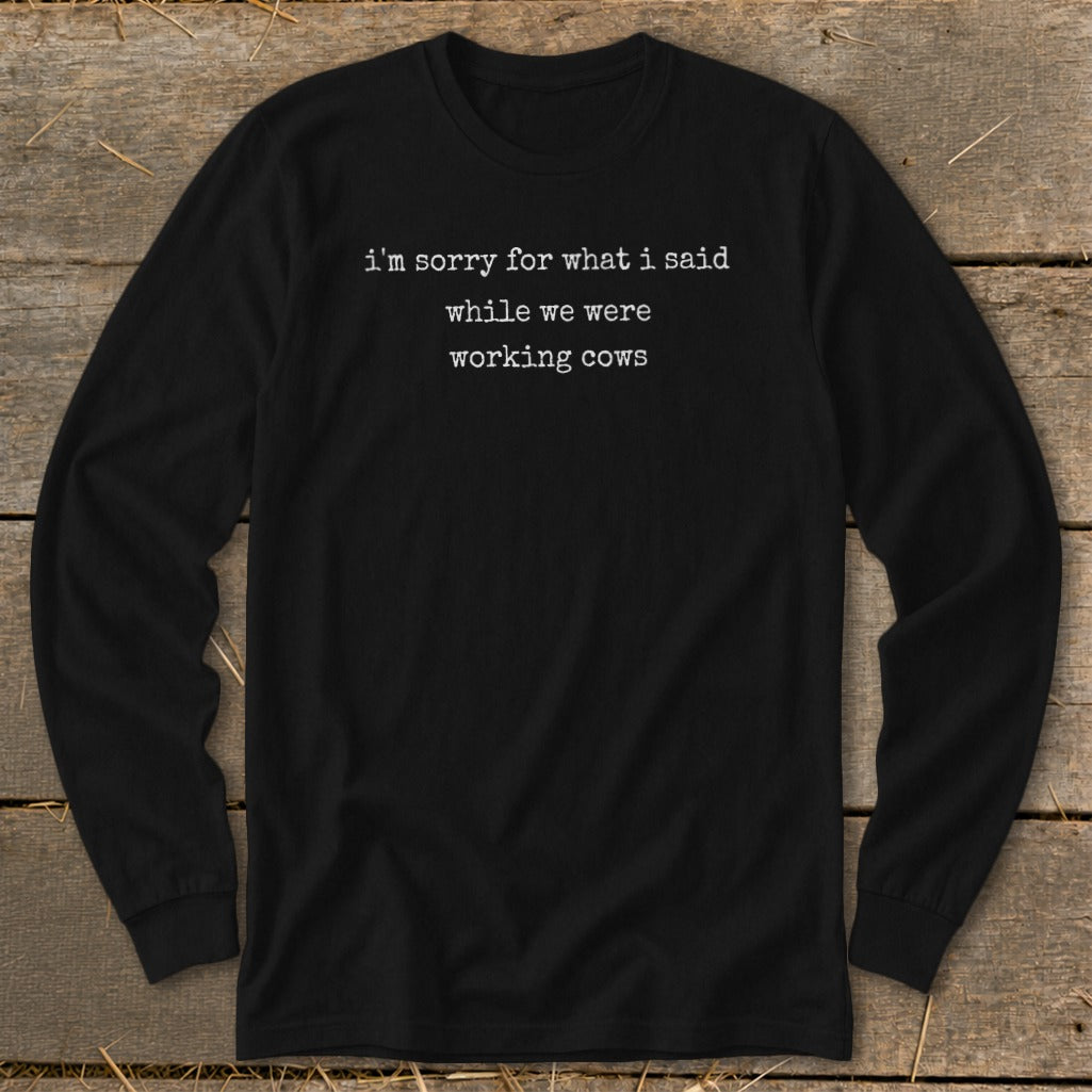 Black long-sleeve shirt with white text: "i'm sorry for what i said while we were working cows."