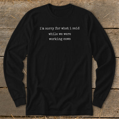 Black long-sleeve shirt with white text: "i'm sorry for what i said while we were working cows."