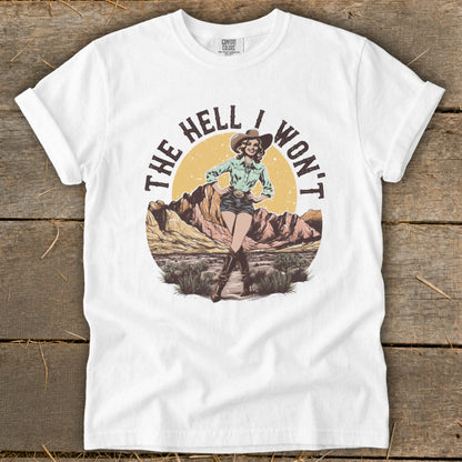 Graphic on white t-shirt: "The Hell I Won't" with a cowgirl in the desert.