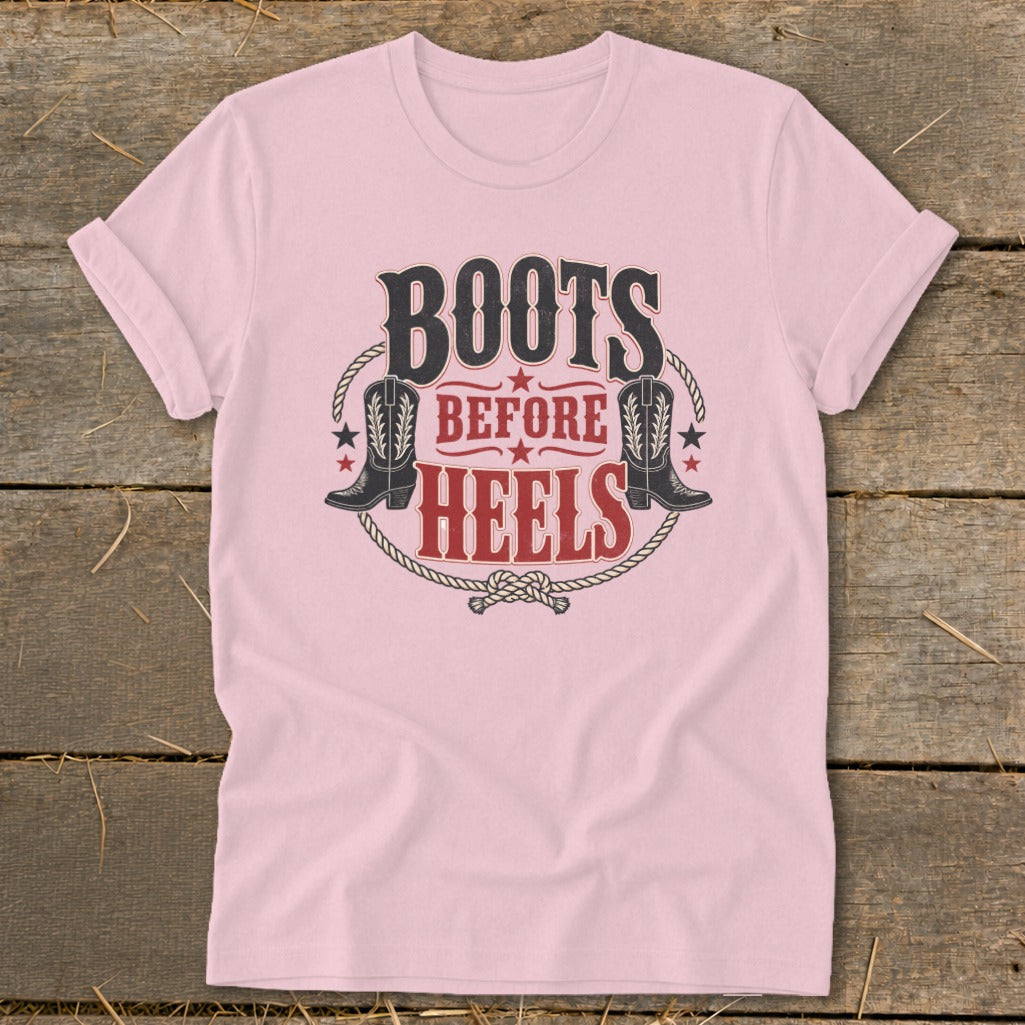 Pink t-shirt with "BOOTS BEFORE HEELS" graphic and cowboy boots.