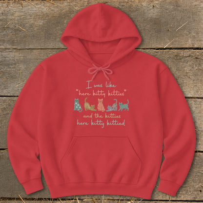 Red hoodie with "I was like 'here kitty kitties' and the kitties here kitty kittied" text and colorful kittens.