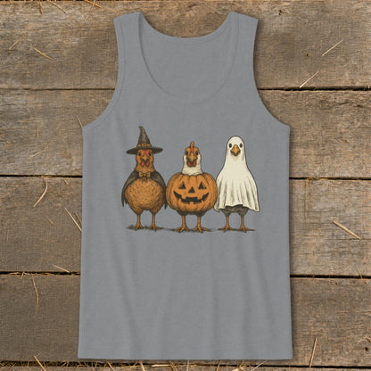 Three chickens dressed for Halloween: one as a witch, one as a pumpkin, and one as a ghost.
