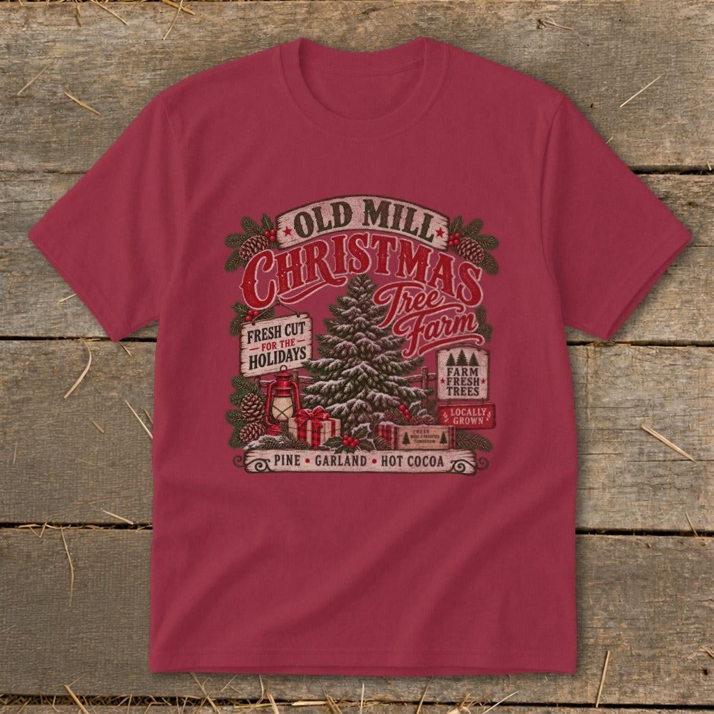 "Old Mill Christmas Tree Farm" graphic with vintage elements on a burgundy t-shirt.