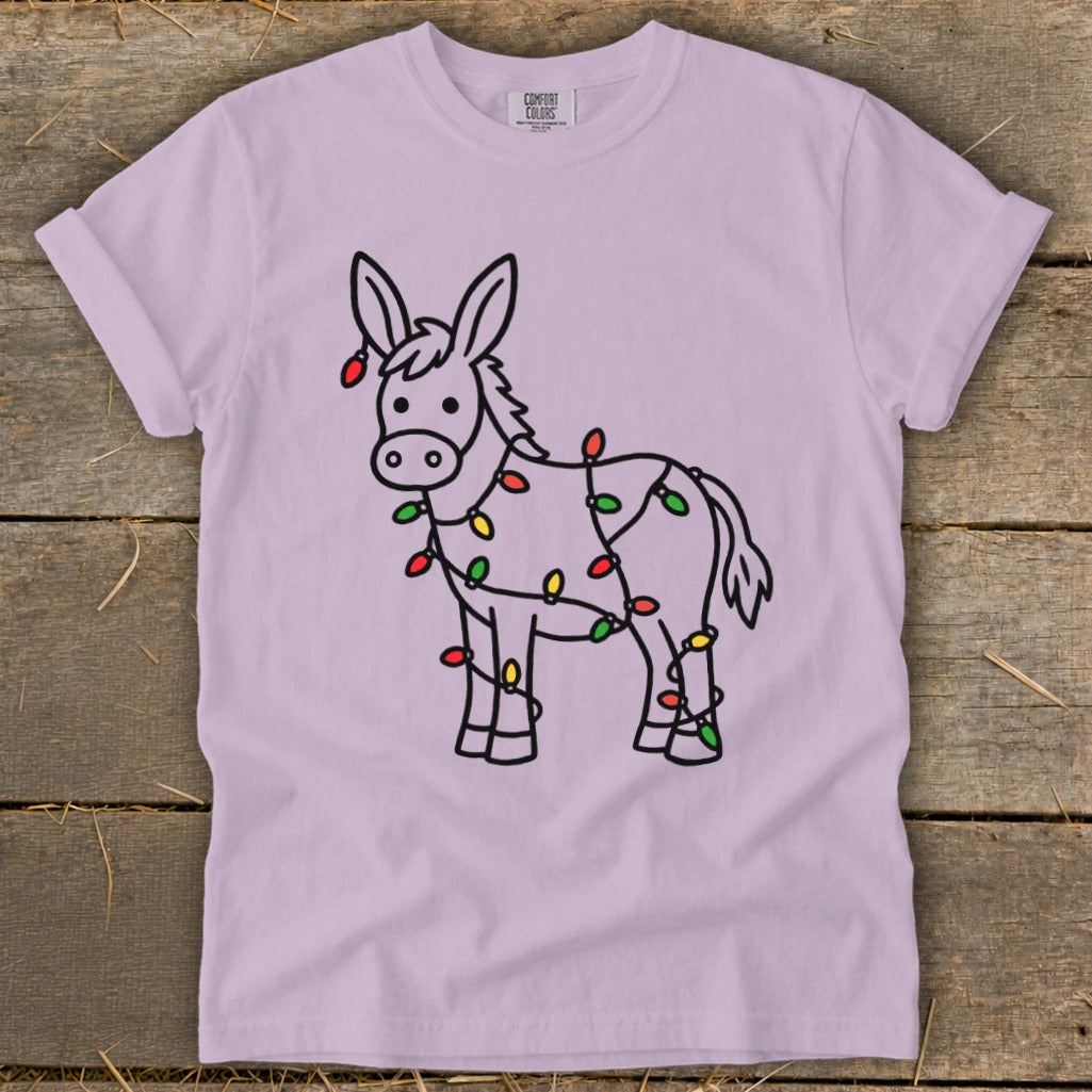 Donkey wrapped in colorful Christmas lights on a light purple t-shirt.
