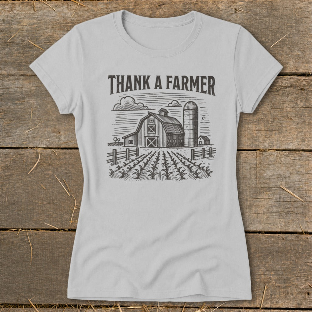Light gray t-shirt with "THANK A FARMER" text above a barn and field illustration.
