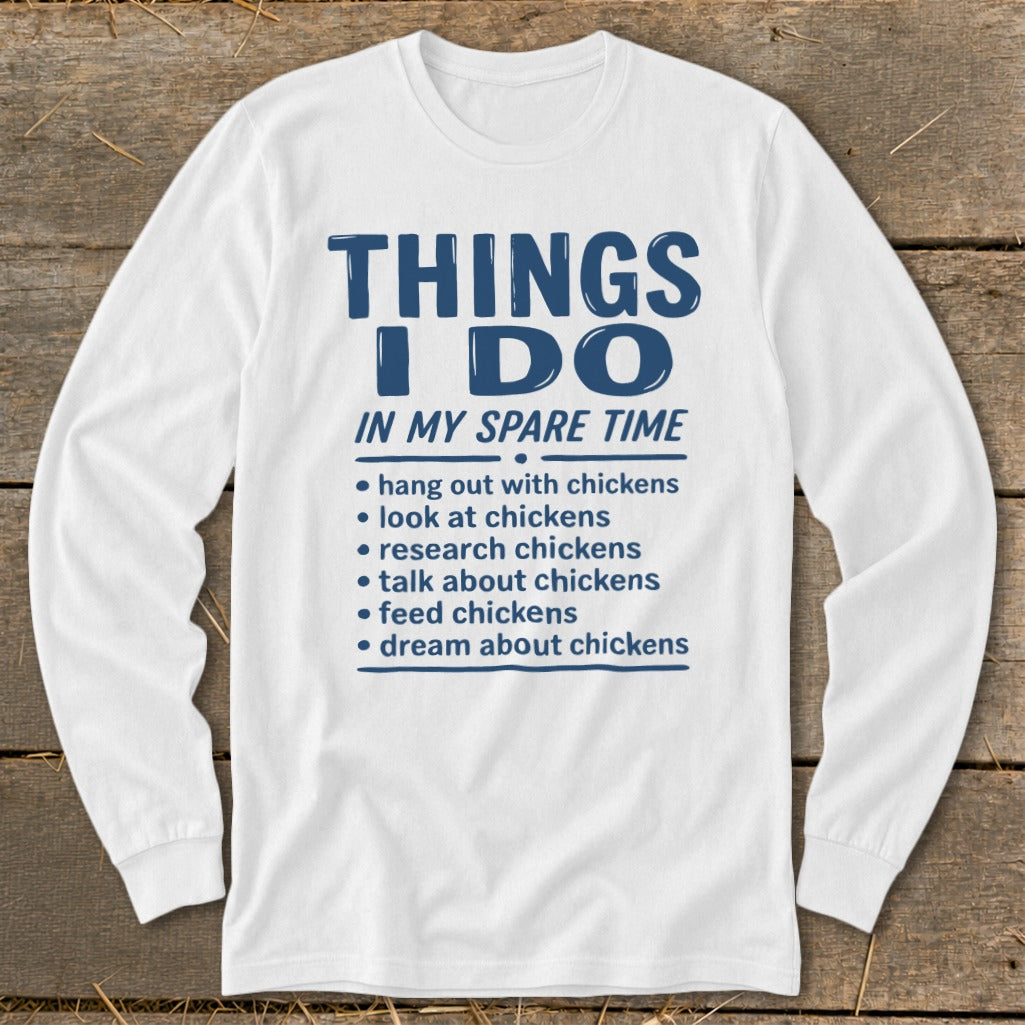 White long-sleeve shirt with blue text: "Things I Do In My Spare Time" and a list about chickens.