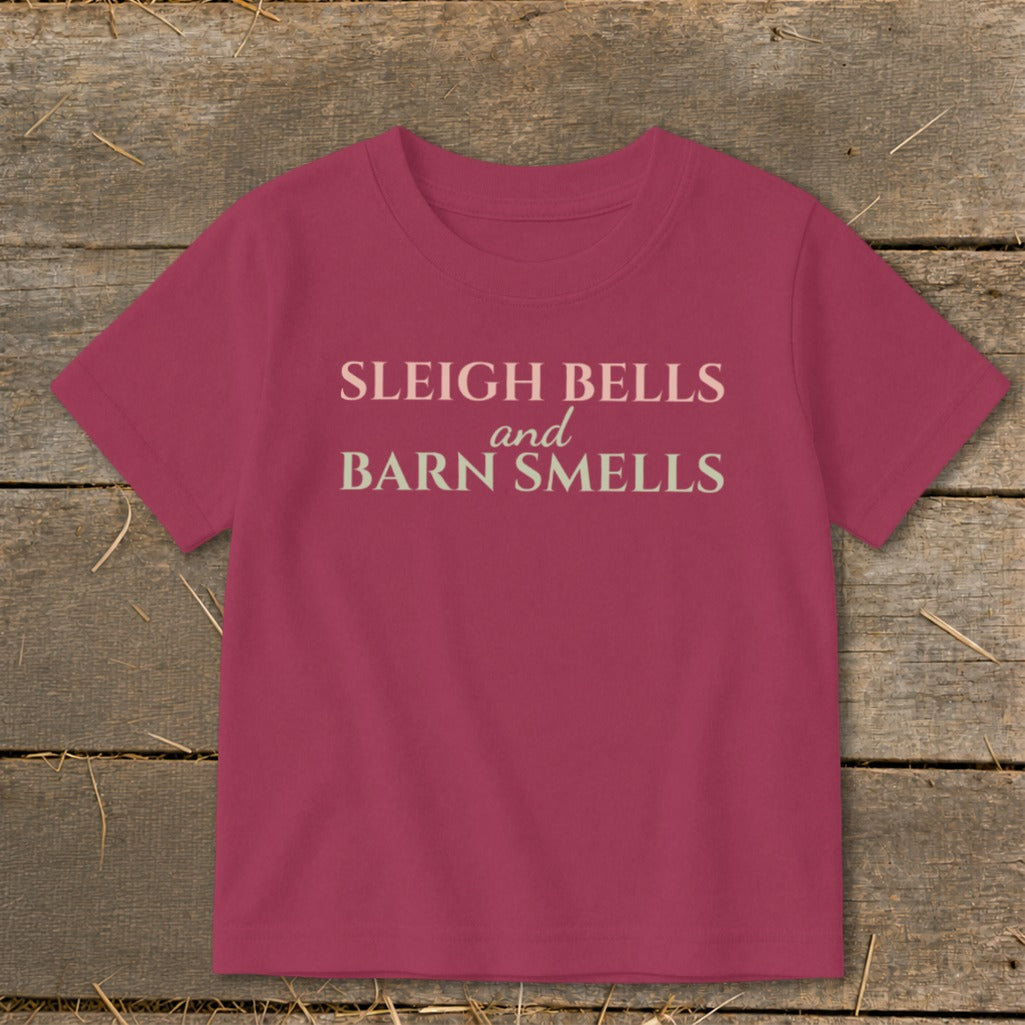 Pink t-shirt with "Sleigh Bells and Barn Smells" text.