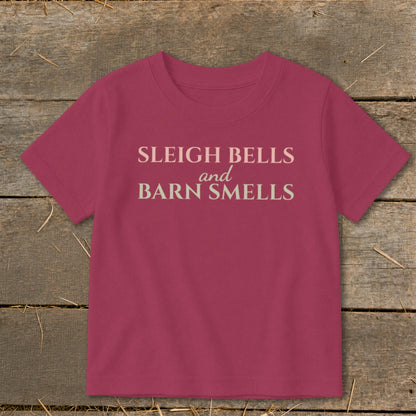 Pink t-shirt with "Sleigh Bells and Barn Smells" text.