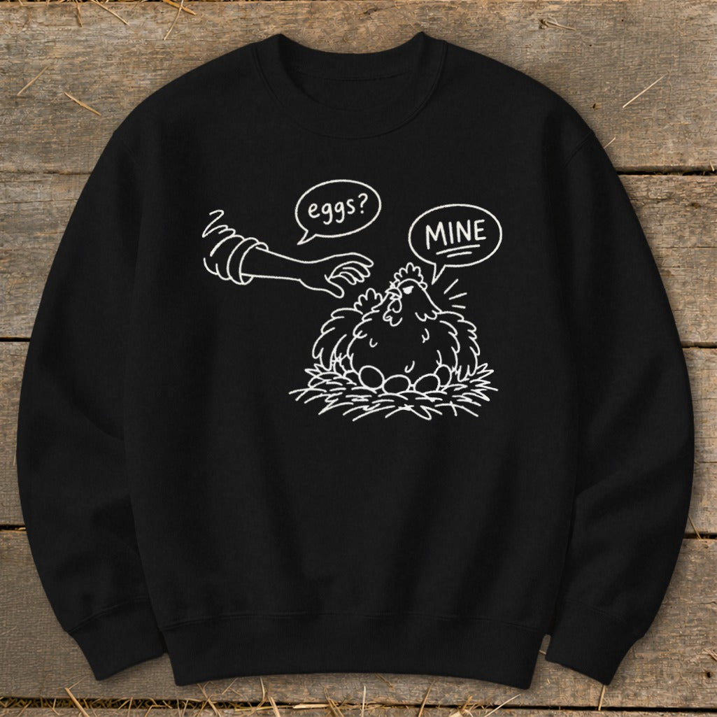 Black sweatshirt with white line drawing of a chicken on a nest of eggs.