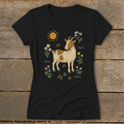 Black t-shirt with a brown and white goat surrounded by flowers and sun.