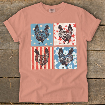 Four patterned chickens in squares on a peach t-shirt.