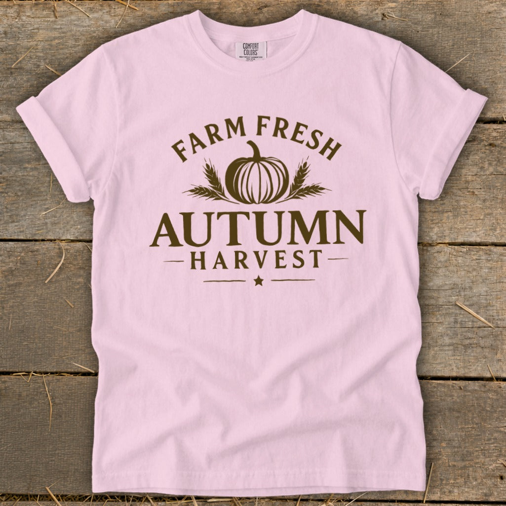 Pink t-shirt with brown text and pumpkin graphic reading "Farm Fresh Autumn Harvest".