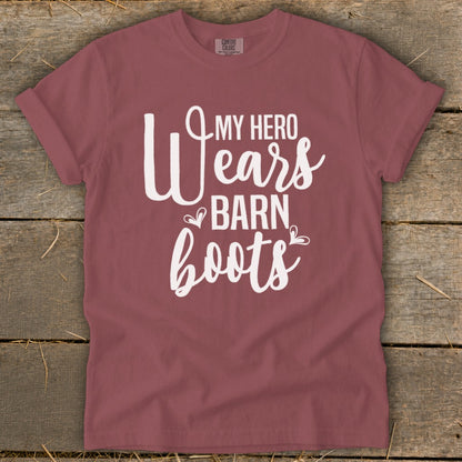 Maroon t-shirt with white text that reads "My hero wears barn boots."