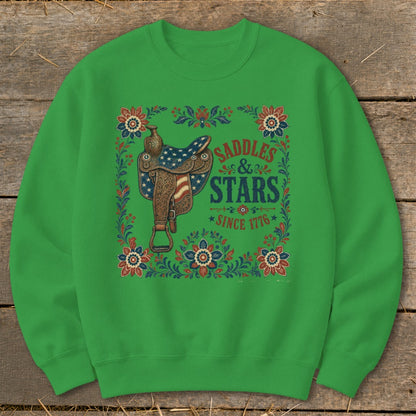 Green sweatshirt with "Saddles & Stars Since 1776" text and patriotic saddle graphic.