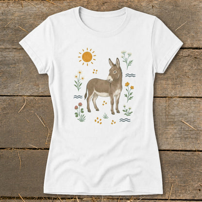 White t-shirt with a watercolor illustration of a donkey surrounded by flowers and a sun.