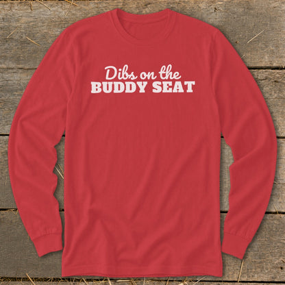 Red long-sleeve shirt with white text "Dibs on the BUDDY SEAT".