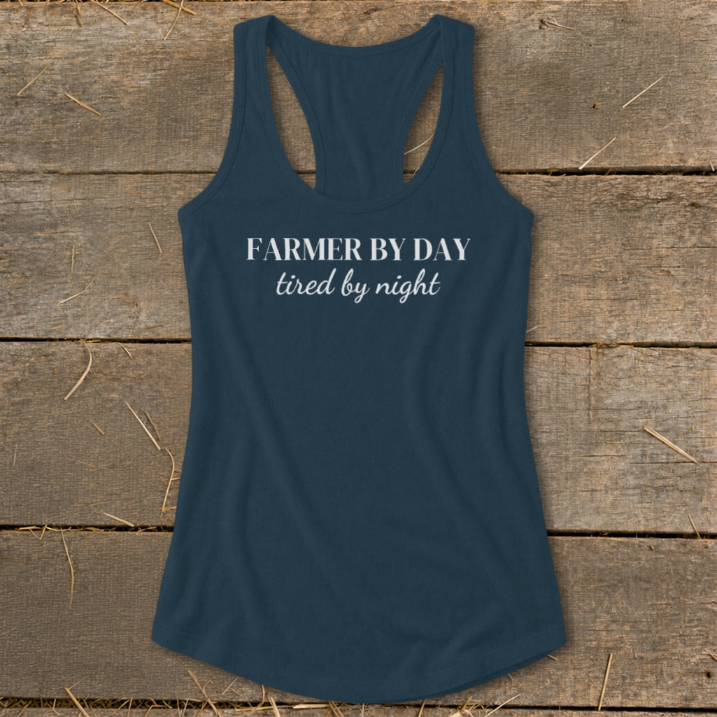 Navy racerback tank top with white text "FARMER BY DAY tired by night".