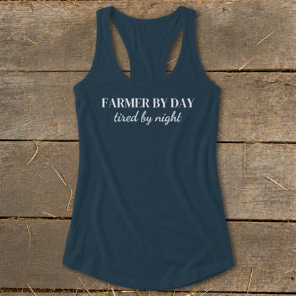 Navy racerback tank top with white text "FARMER BY DAY tired by night".