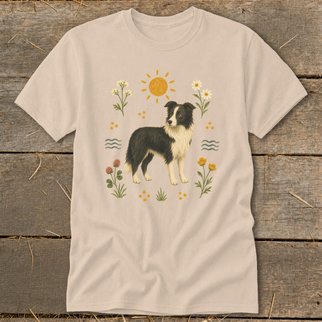 Light beige t-shirt with a Border Collie graphic surrounded by flowers, sun, and water waves.