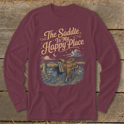 Maroon long-sleeved shirt with a graphic featuring a saddle on a fence, flowers, and text that reads The Saddle Is My Happy Place.