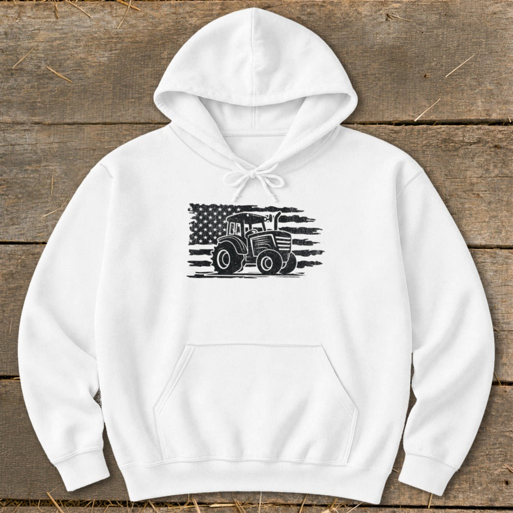 White hoodie with a black graphic of a tractor in front of a distressed American flag.