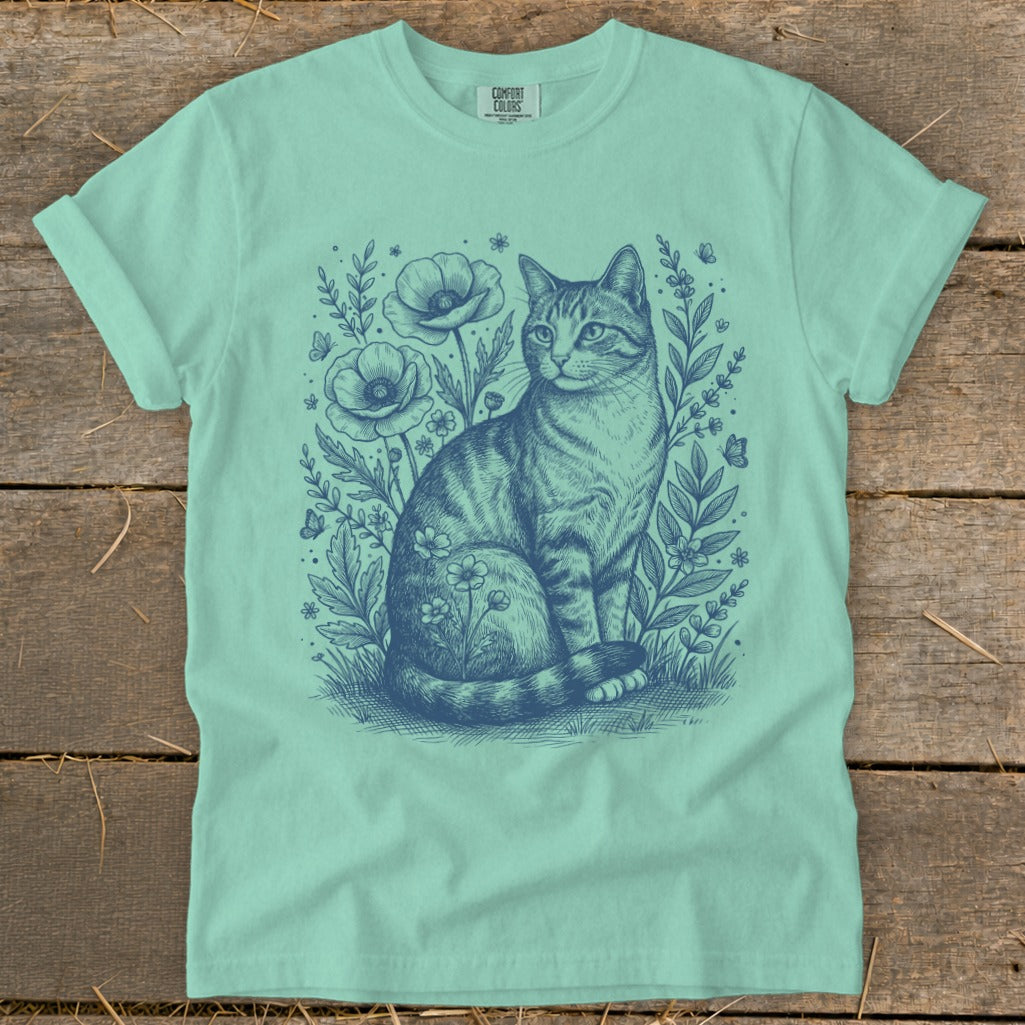 Tabby cat sitting among flowers and butterflies, graphic design on t-shirt.