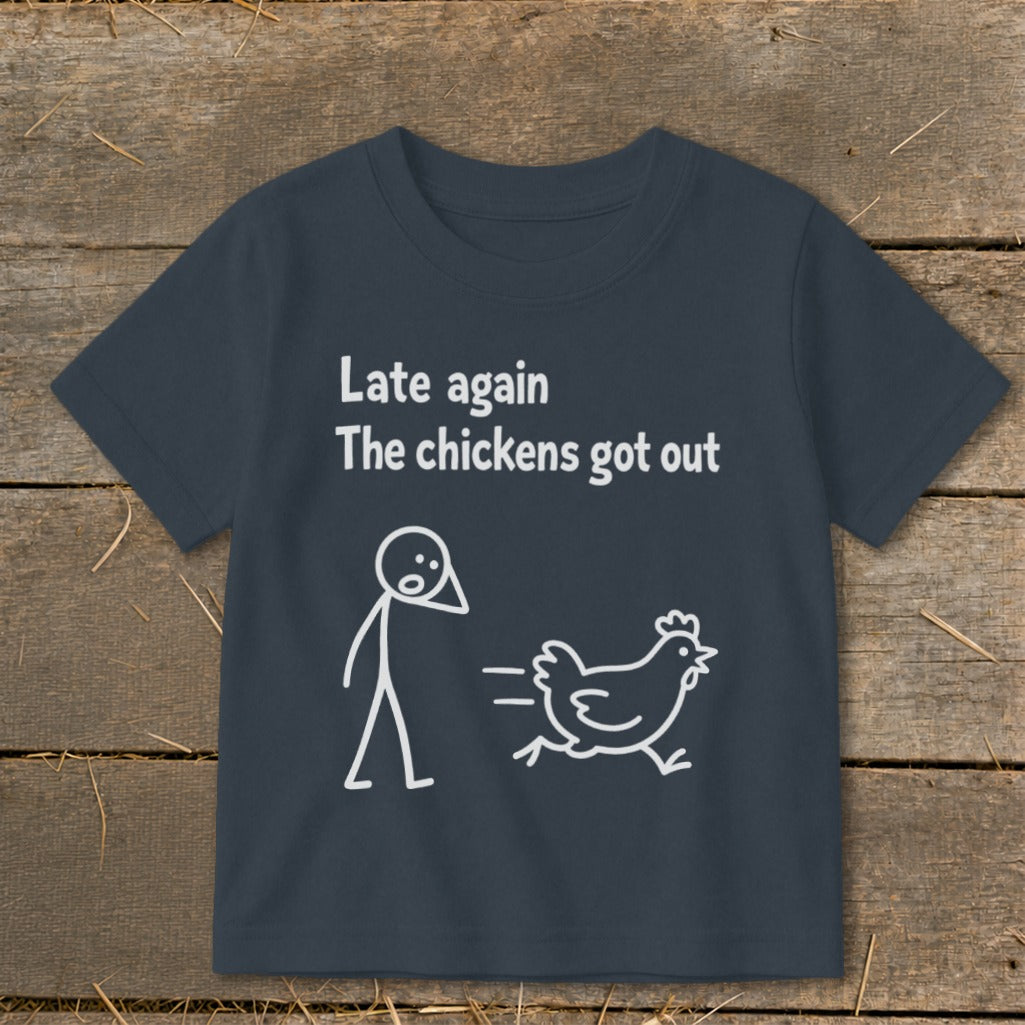 Dark t-shirt with white graphic: "Late again The chickens got out" and stick figure.