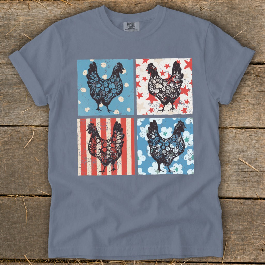 T-shirt featuring a distressed patriotic collage of four roosters with floral and star patterns.