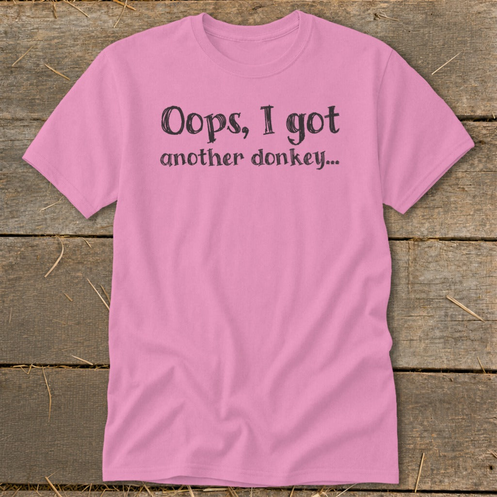 Pink t-shirt with black text that reads "Oops, I got another donkey..."
