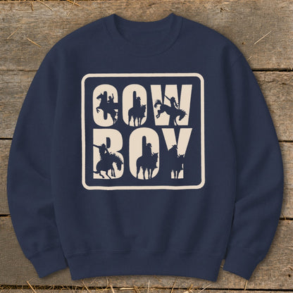 Navy sweatshirt with "COW BOY" text and cowboy silhouettes in a cream box.