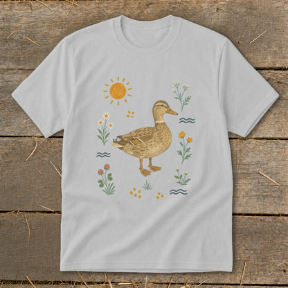 Light gray t-shirt with a watercolor illustration of a duck surrounded by flowers, sun, and water waves.